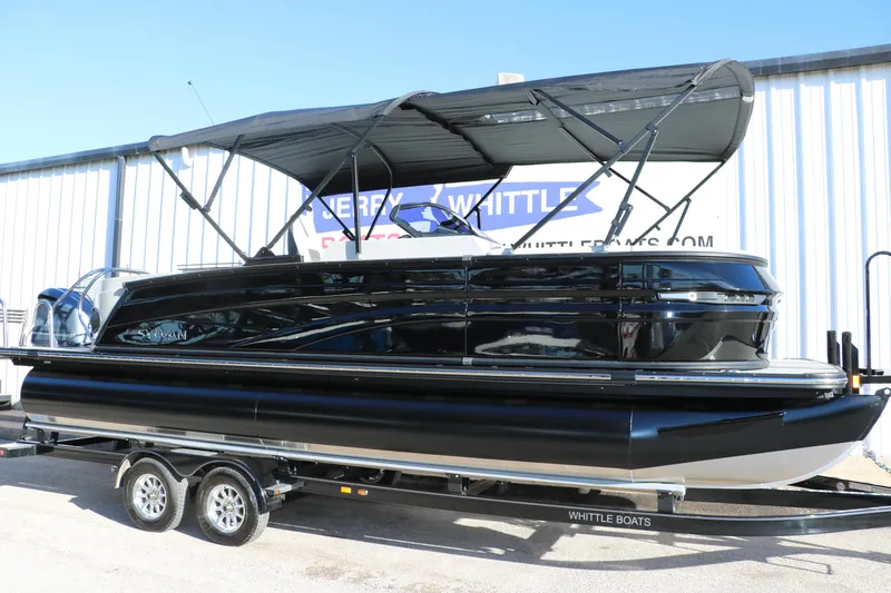 Slide: The Image of 2025 Sylvan G3 CLZ DH pontoon boat with black exterior on a trailer. - 12
