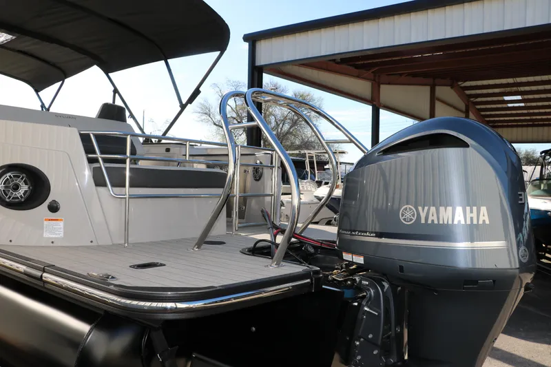 Slide: The Image of 2025 Sylvan G3 CLZ DH boat with Yamaha outboard motor, docked under a shelter. - 5