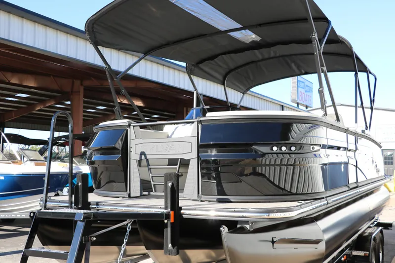 Slide: The Image of 2025 Sylvan G3 CLZ DH pontoon boat with canopy, docked outdoors. - 7