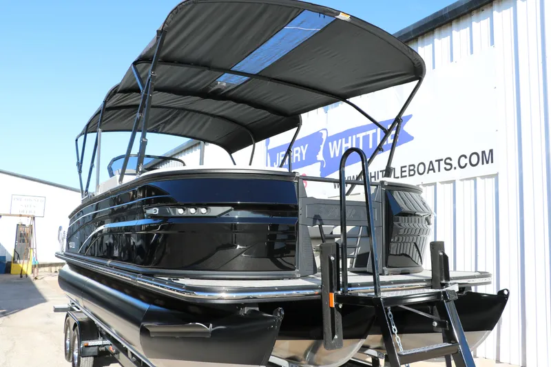 Slide: The Image of 2025 Sylvan G3 CLZ DH pontoon boat with canopy, displayed outdoors. - 9