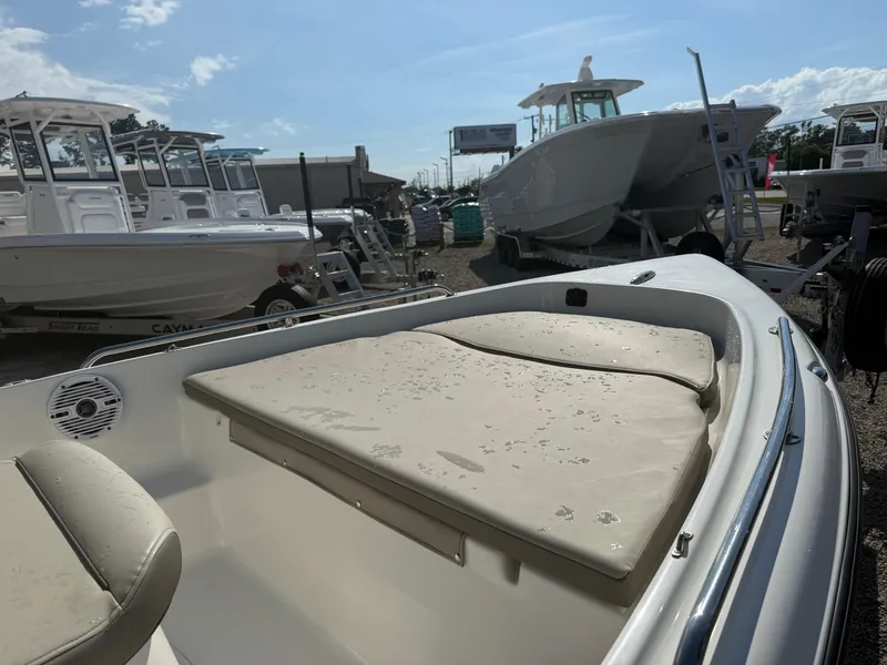 Slide: The Image of 2023 Key West 1720 Center Console boat with cushioned seating, displayed outdoors. - 12