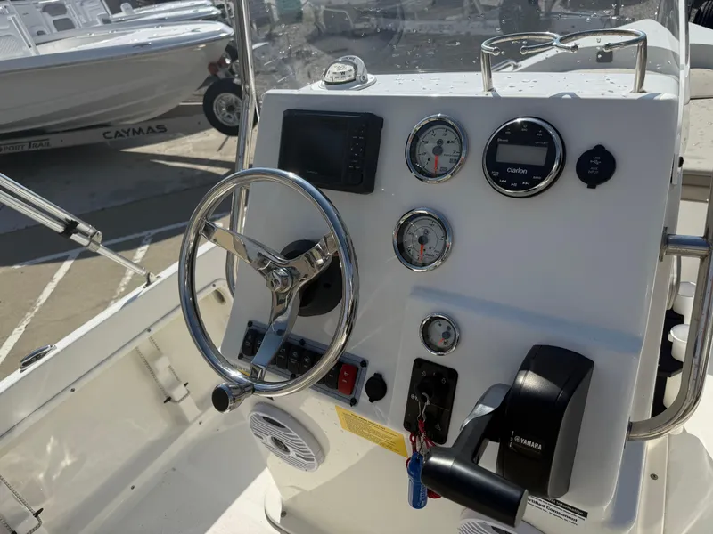 Slide: The Image of 2023 Key West 1720 Center Console boat dashboard with steering wheel and gauges. - 16