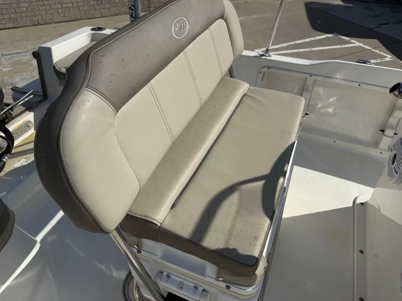Slide: The Image of 2023 Key West 1720 Center Console boat seat, beige upholstery, outdoor setting. - 17