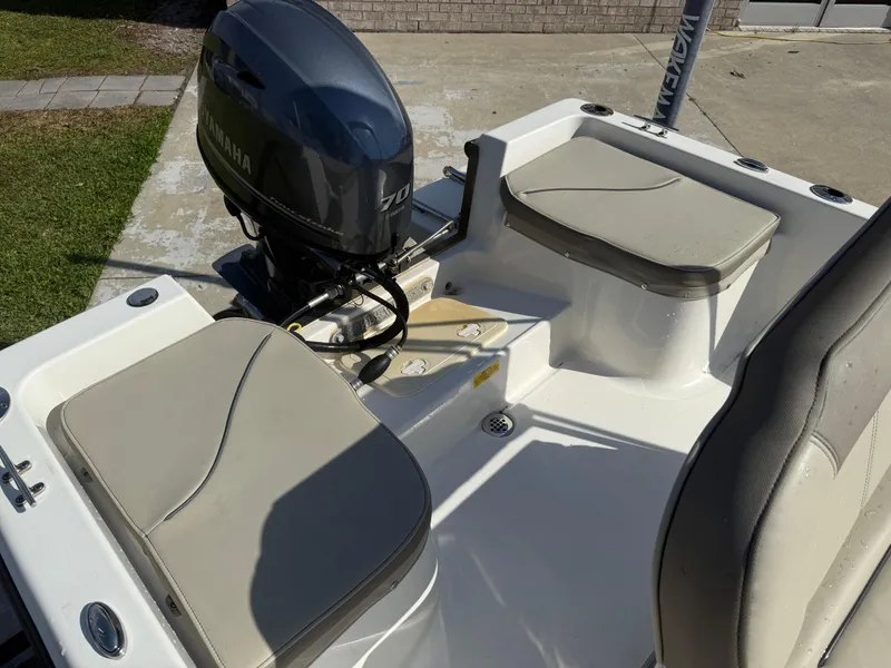 Slide: The Image of 2023 Key West 1720 Center Console boat with Yamaha outboard motor and cushioned seating. - 18