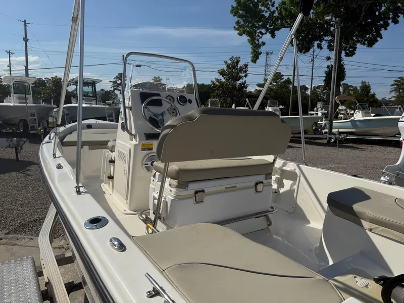 Slide: The Image of 2023 Key West 1720 Center Console boat with beige seating and steering console. - 19
