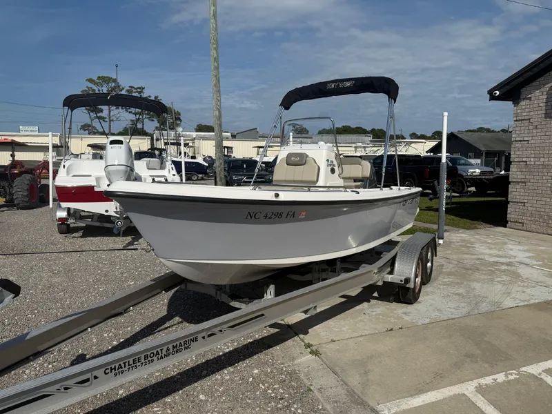 Slide: The Image of 2023 Key West 1720 Center Console boat on trailer in a marina setting. - 4