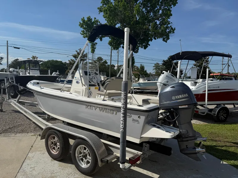 Slide: The Image of 2023 Key West 1720 Center Console boat on trailer with Yamaha engine, parked outdoors. - 7