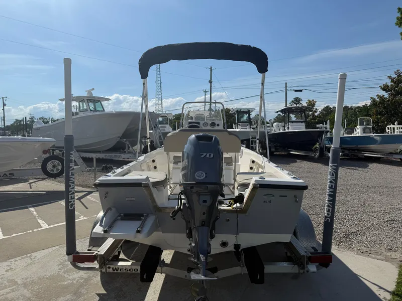 Slide: The Image of 2023 Key West 1720 Center Console boat with outboard motor, parked on a trailer. - 9