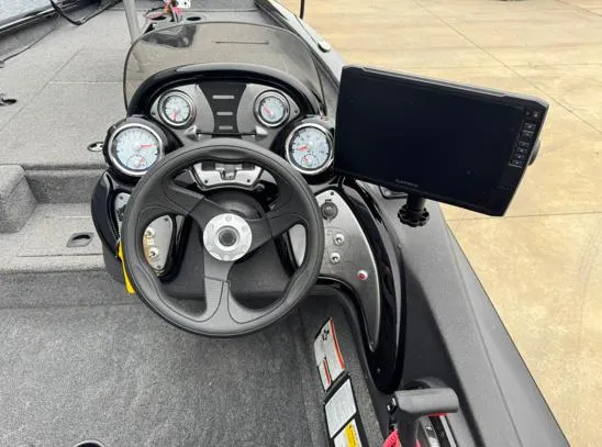 Slide: The Image of 2021 Tracker PRO TEAM 175 TWX boat dashboard with steering wheel and gauges. - 6