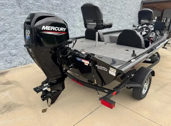 Slide: The Image of 2021 Tracker PRO TEAM 175 TWX boat with Mercury engine, parked on concrete. - 7
