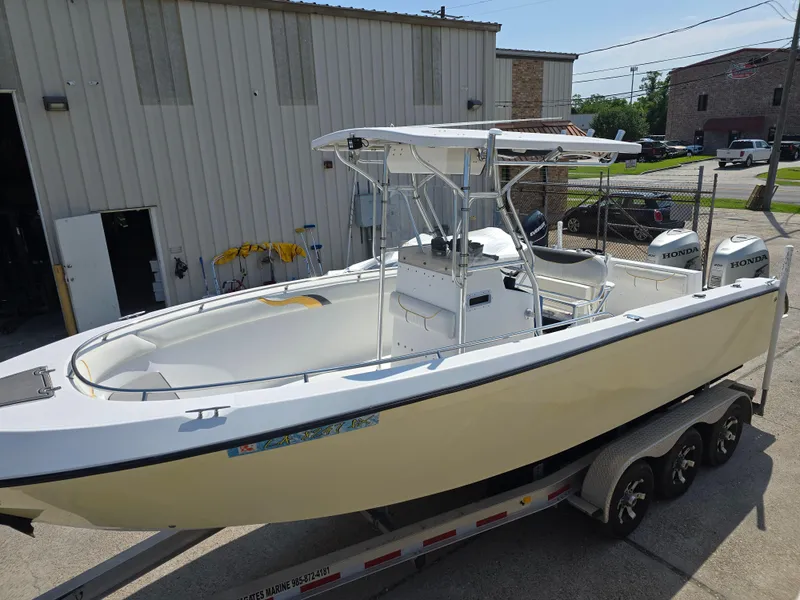 Slide: The Image of 2005 Sea Chaser 2600 Offshore boat on trailer, parked outside a building. - 1