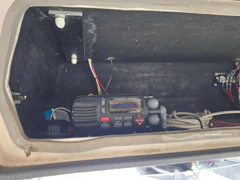 Slide: The Image of 2005 Sea Chaser 2600 Offshore boat radio compartment with wiring and communication device. - 12