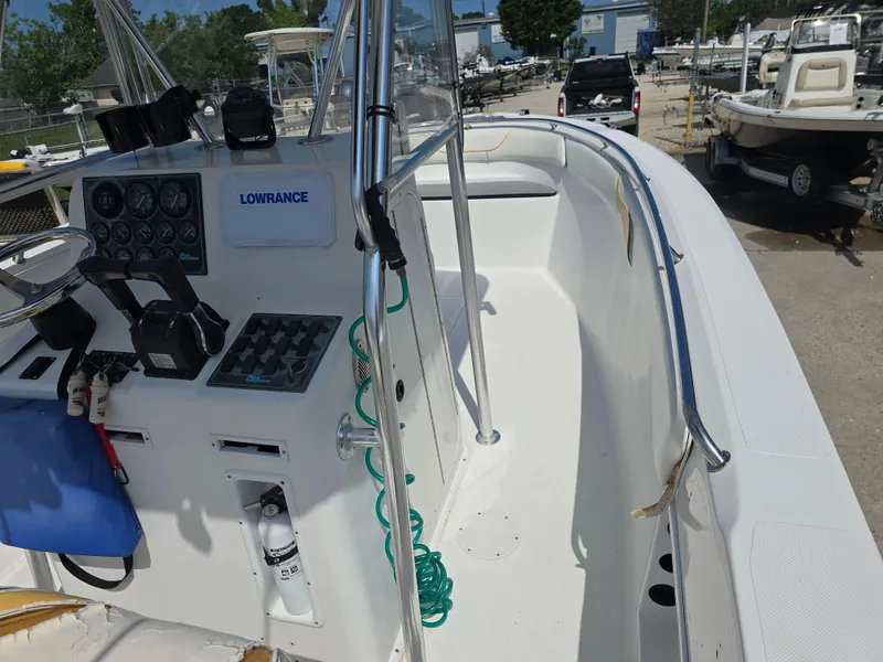 Slide: The Image of 2005 Sea Chaser 2600 Offshore boat cockpit with control panel and seating area. - 16