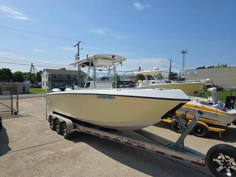 Slide: The Image of 2005 Sea Chaser 2600 Offshore boat on trailer, parked outdoors under clear sky. - 2