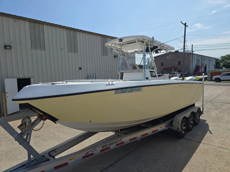Slide: The Image of 2005 Sea Chaser 2600 Offshore boat on trailer, parked outside industrial building. - 3