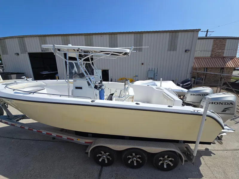 Slide: The Image of 2005 Sea Chaser 2600 Offshore boat on trailer, parked outside a warehouse. - 4