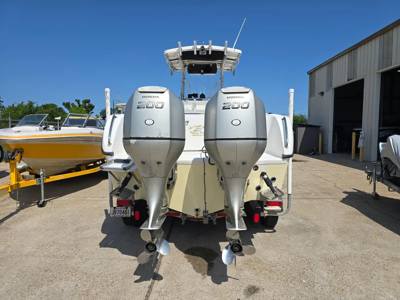 Slide: The Image of 2005 Sea Chaser 2600 Offshore boat with dual Honda 200 engines, parked outdoors. - 6
