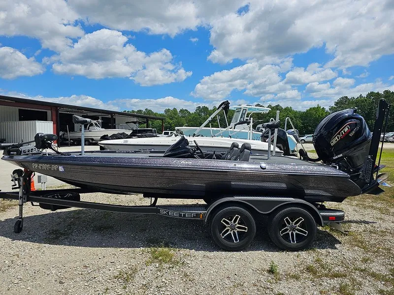 Slide: The Image of 2022 Skeeter ZX200 boat on trailer under a partly cloudy sky. - 1