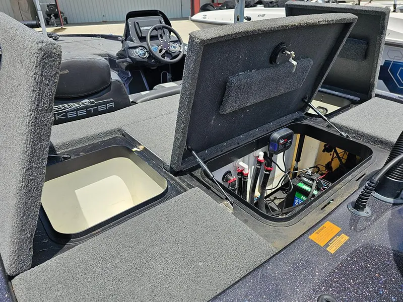 Slide: The Image of 2022 Skeeter ZX200 boat with open storage compartments and visible wiring. - 10