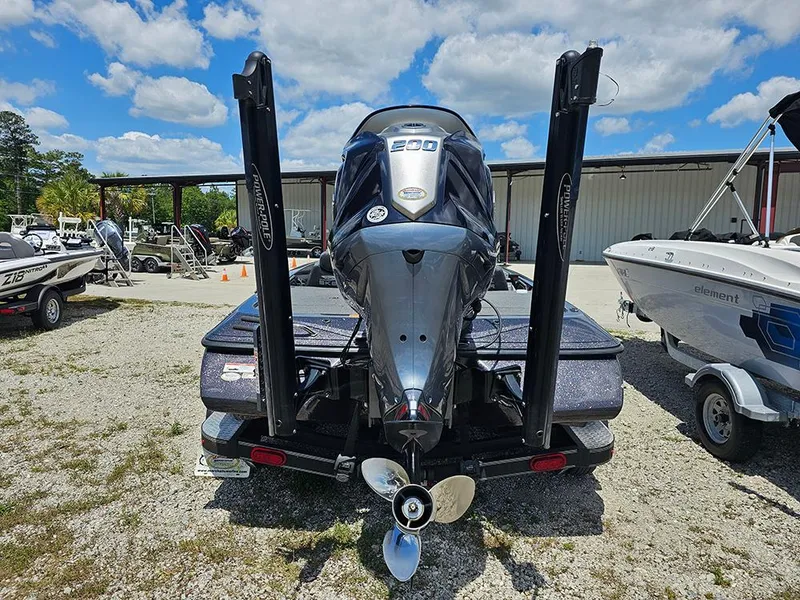 Slide: The Image of 2022 Skeeter ZX200 boat with powerful engine, parked outdoors under a blue sky. - 7