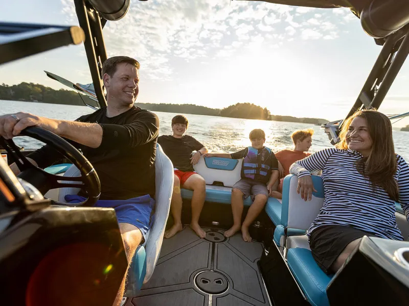 Slide: The Image of Family enjoying a ride on a 2025 HEYDAY WAKE BOATS WT-SURF at sunset. - 11