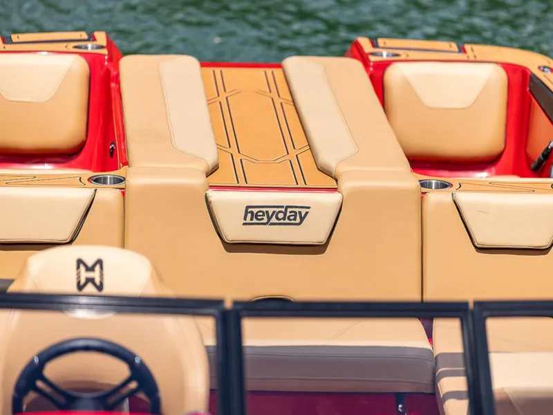 Slide: The Image of 2025 HEYDAY WAKE BOATS WT-SURF with tan seating and logo, on water. - 14
