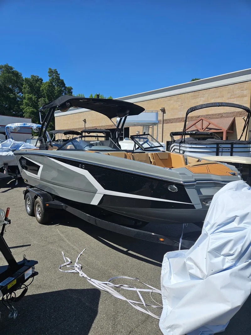 Slide: The Image of 2025 HEYDAY WAKE BOATS WT-SURF on trailer, sleek design, outdoor display. - 2