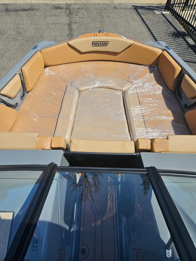 Slide: The Image of 2025 HEYDAY WAKE BOATS WT-SURF interior with tan seating and protective wrap. - 4
