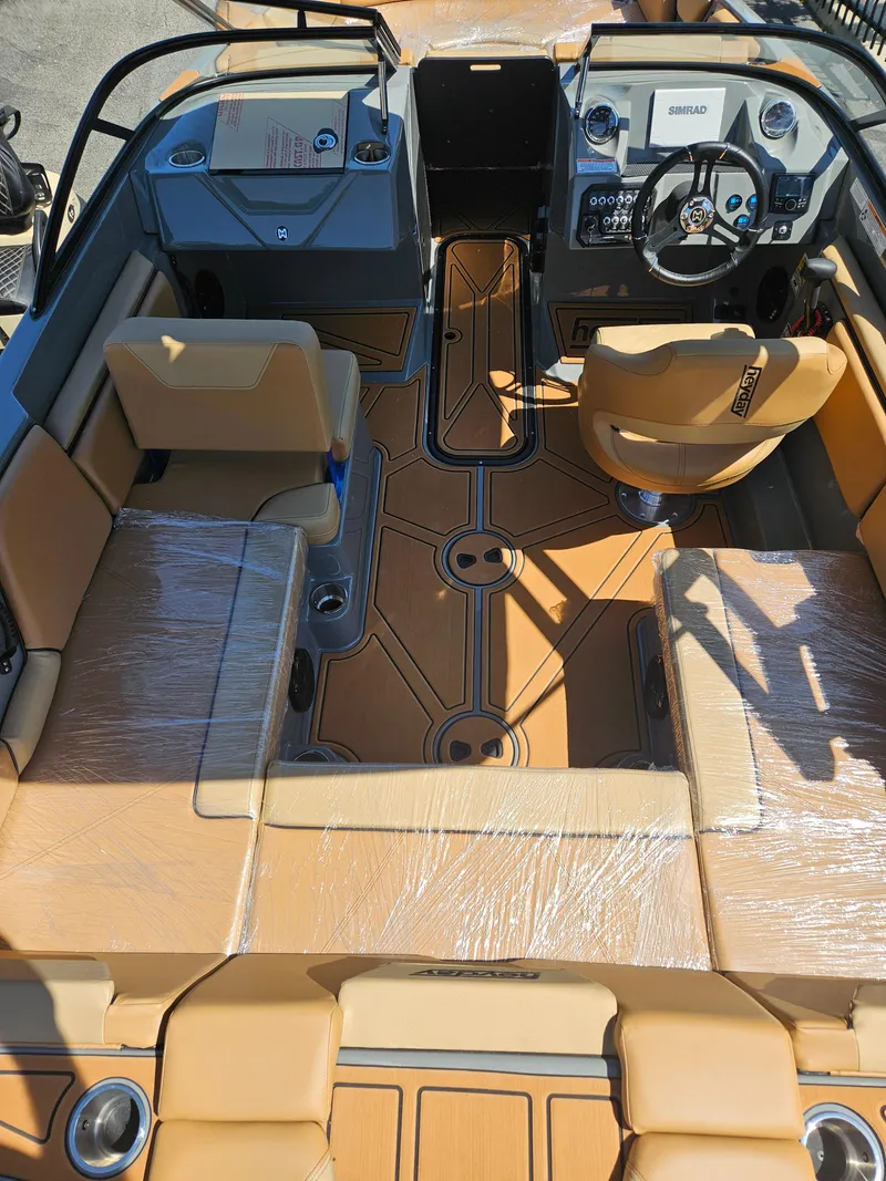Slide: The Image of 2025 HEYDAY WAKE BOATS WT-SURF interior with tan seating and modern dashboard. - 5