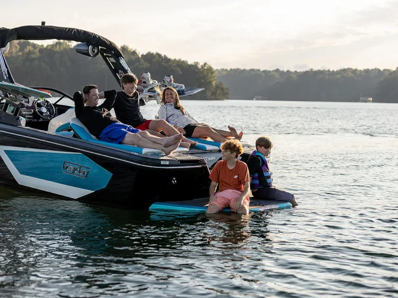 Slide: The Image of Family enjoying a day on a 2025 HEYDAY WAKE BOATS WT-SURF on a serene lake. - 9