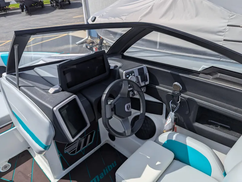 Slide: The Image of 2022 Malibu Wakesetter 23 LSV boat interior with modern dashboard and steering wheel. - 11