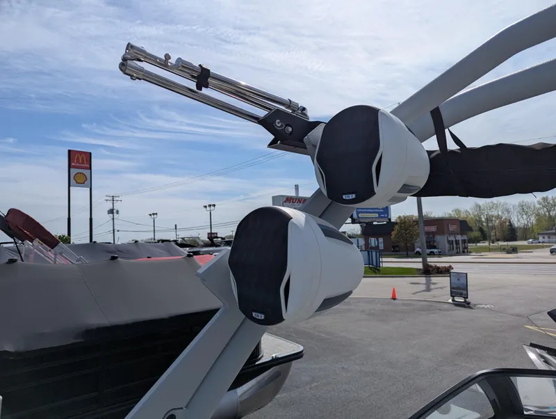 Slide: The Image of 2022 Malibu Wakesetter 23 LSV boat speakers and tower in a parking lot. - 16