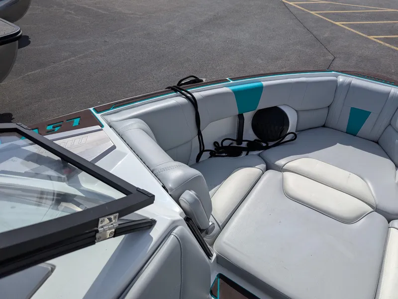Slide: The Image of 2022 Malibu Wakesetter 23 LSV boat interior with gray and teal seating. - 17