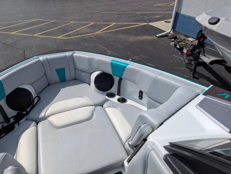 Slide: The Image of 2022 Malibu Wakesetter 23 LSV boat interior with white and teal seating. - 19