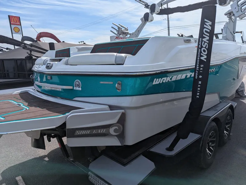 Slide: The Image of 2022 Malibu Wakesetter 23 LSV boat on trailer, teal and white design, rear view. - 5