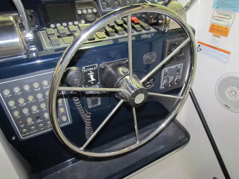 Slide: The Image of 1999 Tiara Yachts 3500 Open helm with steering wheel and control panel. - 11