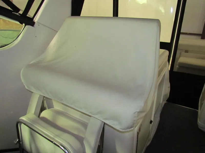 Slide: The Image of 1999 Tiara Yachts 3500 Open interior with white cushioned seating. - 14