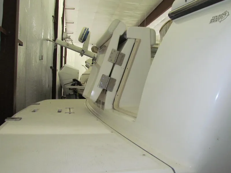 Slide: The Image of 1999 Tiara Yachts 3500 Open in storage, showcasing rear deck and equipment. - 16