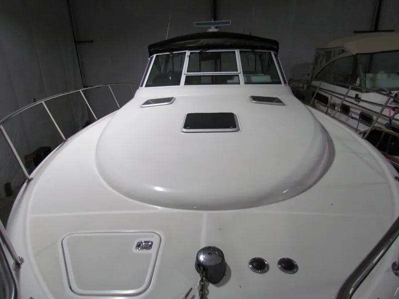 Slide: The Image of 1999 Tiara Yachts 3500 Open boat deck with hatches and railing in a storage facility. - 18