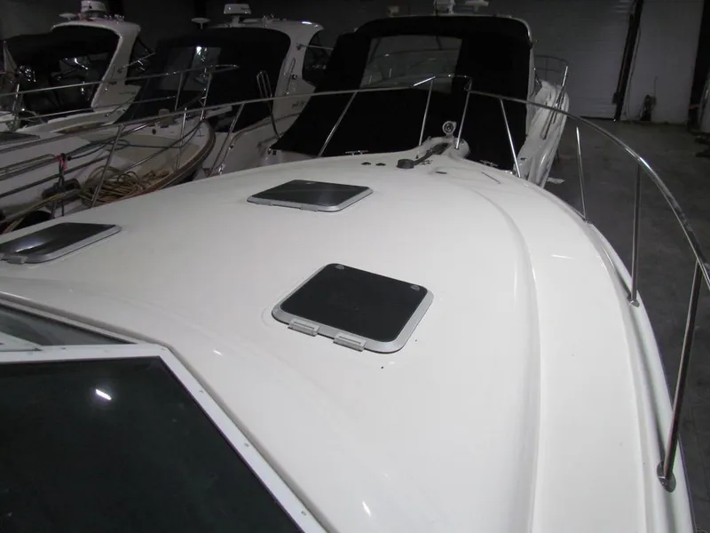 Slide: The Image of 1999 Tiara Yachts 3500 Open boat deck with hatches in a marina. - 20