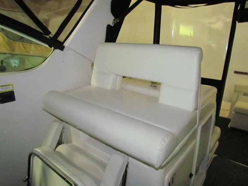 Slide: The Image of 1999 Tiara Yachts 3500 Open interior with white cushioned seating. - 22