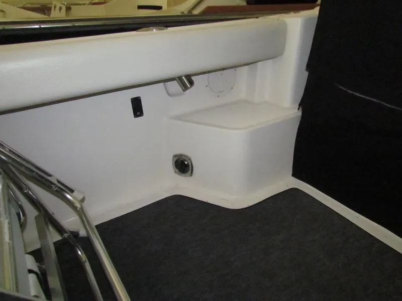 Slide: The Image of Interior view of a 1999 Tiara Yachts 3500 Open, showcasing seating and storage area. - 23