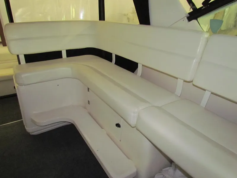 Slide: The Image of 1999 Tiara Yachts 3500 Open interior seating, featuring white cushioned benches. - 26