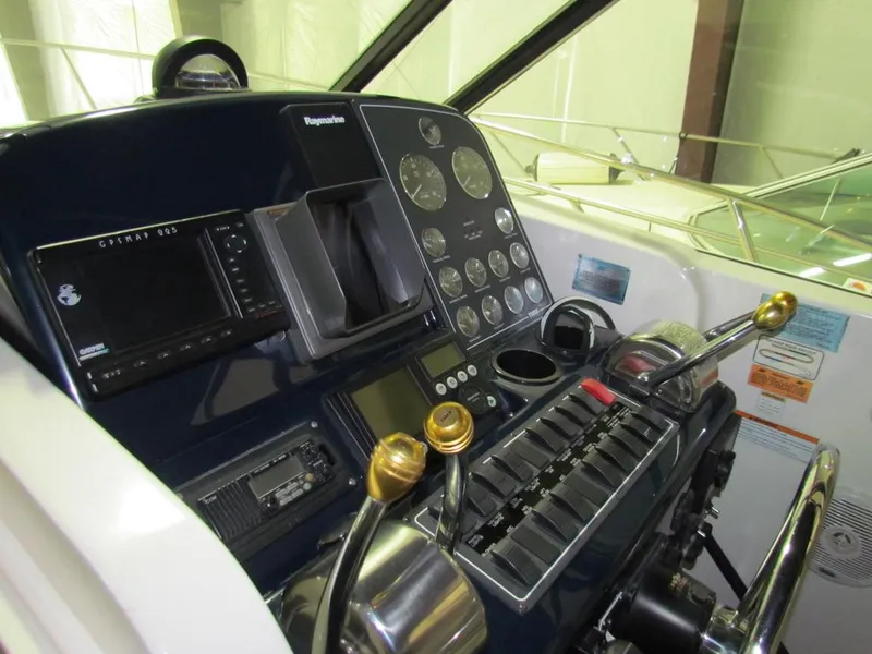 Slide: The Image of 1999 Tiara Yachts 3500 Open helm with navigation controls and gauges. - 29