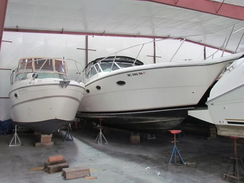 Slide: The Image of 1999 Tiara Yachts 3500 Open stored indoors, supported by stands and blocks. - 3