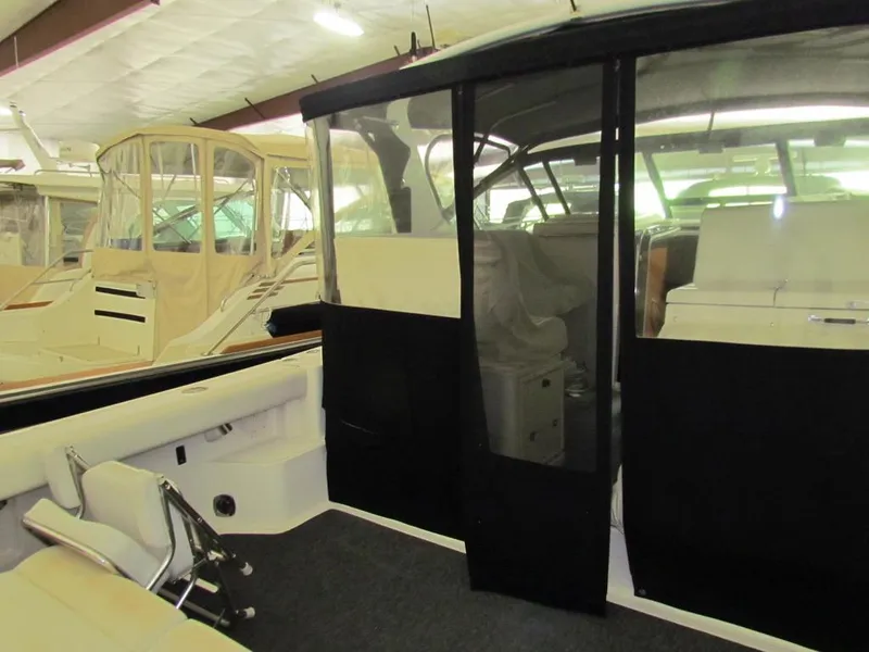 Slide: The Image of 1999 Tiara Yachts 3500 Open interior view with seating and covered cockpit. - 31