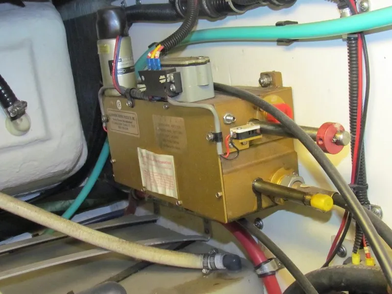 Slide: The Image of Engine compartment of 1999 Tiara Yachts 3500 Open, showcasing mechanical components and wiring. - 32