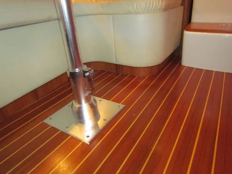 Slide: The Image of Interior of 1999 Tiara Yachts 3500 Open, featuring polished wood flooring and metal support. - 33