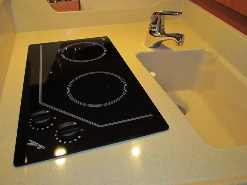 Slide: The Image of 1999 Tiara Yachts 3500 Open kitchen with stovetop and sink. - 34