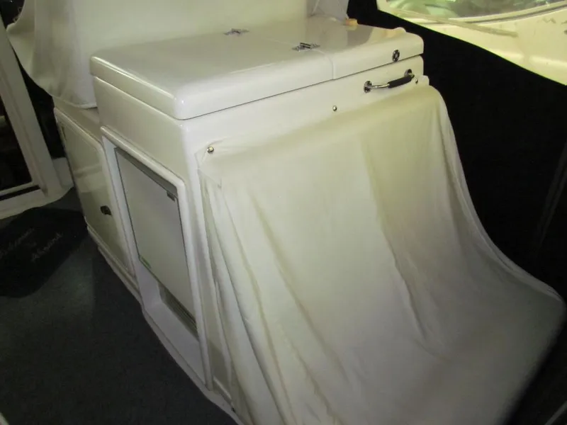 Slide: The Image of 1999 Tiara Yachts 3500 Open interior with white cabinetry and fabric cover. - 4